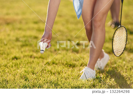 Close up view of woman that is taking shuttlecock from the ground Close up view of woman that is taking shuttlecock from the ground 132264298