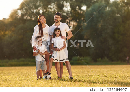 Happy family is standing together on the field Happy family is standing together on the field 132264407