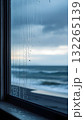 Raindrops on the window overlooking the sea, background. Gloomy autumn day, no people, vertical image. 132265139