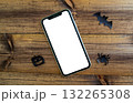 Mockup, smartphone, paper black bat, spider and pumpkin on wooden background. Halloween background. 132265308