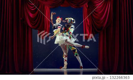 Embrace of motion. Mime and ballerina dancing in spotlight on theater stage. 132266363