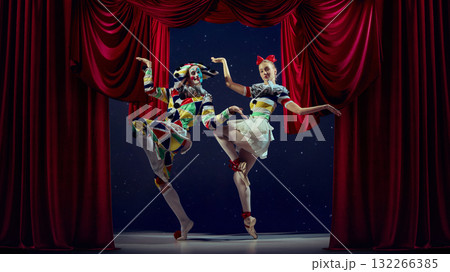 Spotlight rhythm. Mime and ballerina performing synchronized pose on theater stage. 132266385