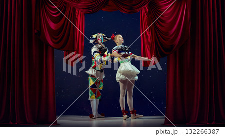 Masquerade magic. Mime and ballerina performing under red curtain with festive lighting. Masquerade magic. Mime and ballerina performing under red curtain with festive lighting. 132266387