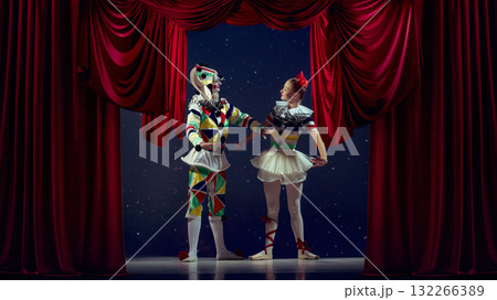 Life on stage. Mime and ballerina standing together on theater stage in colorful costumes. 132266389