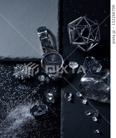 Minimalist winter flat lay showcasing a sleek watch and icy crystals Minimalist winter flat lay showcasing a sleek watch and icy crystals 132266706