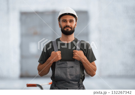 Beautiful portrait. Male worker is in the empty warehouse Beautiful portrait. Male worker is in the empty warehouse 132267342
