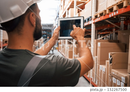 Using the digital tablet. Foreman is in the storehouse, shipping distribution business 132267500