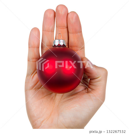 Single hand holding glossy red christmas ball ornament with metallic shine, isolated on transparent background for holiday designs 132267532