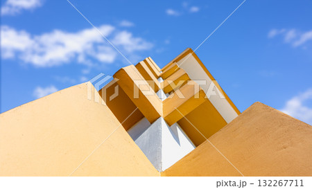 Modern abstract architecture with yellow geometric lines and blue sky background 132267711