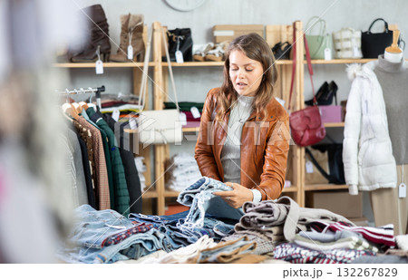 Elegance young girl buying jeans trousers in clothing store. Shopping and seasonal sales concept 132267829