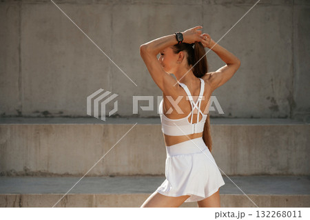 Rear view. Young skinny fitness woman is outdoors Rear view. Young skinny fitness woman is outdoors 132268011