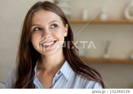 Woman posing in light room looking smiling away in home living area 132268139