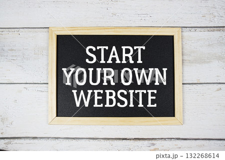 Start Your Own Website text with blackboard on wooden background Start Your Own Website text with blackboard on wooden background 132268614