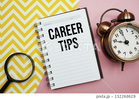 Career Tips text written on notepad with alarm clock and magnifying glass Career Tips text written on notepad with alarm clock and magnifying glass 132268629