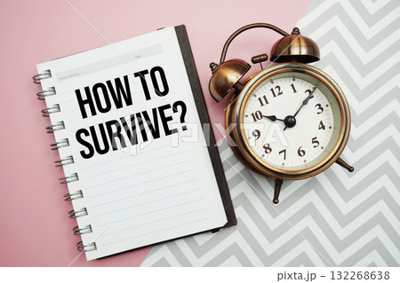 How To Survive? text written on notepad with alarm clock 132268638