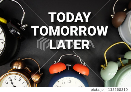 Today Tomorrow Later text with alarm clock on black background Today Tomorrow Later text with alarm clock on black background 132268810