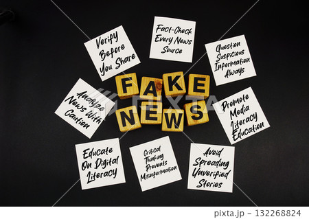 Fake News and Tips for Prevention written on sticky note on black background Fake News and Tips for Prevention written on sticky note on black background 132268824