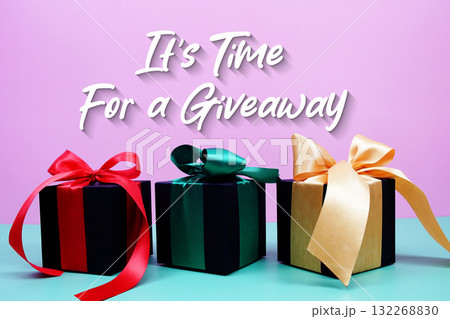 It's Time For A Giveaway text with gift box present on pink and green background 132268830
