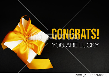 Congrats! You Are Lucky text with gift box present on black background Congrats! You Are Lucky text with gift box present on black background 132268839