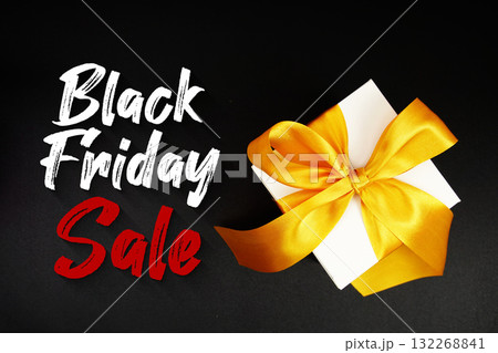 Black Friday Sale text with gift box present on black background 132268841
