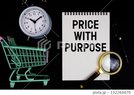 Price with purpose text written on notepad with alarm clock and trolley shopping cart on black background 132268870