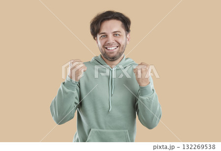 Portrait of happy young man doing winner gesture 132269538