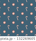 Seamless Christmas pattern with candies. Background with traditional winter sweets on a dark blue background. Lollipops, round caramels, and candy canes. Simple flat vector illustration. 132269605