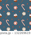 Seamless Christmas pattern with candies. Background with traditional winter sweets on a dark blue background. Lollipops, caramels, candy canes, cakes, and hearts. Simple vector flat illustration. 132269619