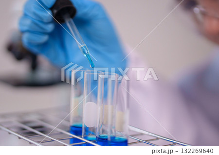 Scientist Hand Pipetting Blue Liquid Test Tubes Scientific Experiment Chemistry Lab Research Analysis Modern Laboratory Scientist Hand Pipetting Blue Liquid Test Tubes Scientific Experiment Chemistry Lab Research Analysis Modern Laboratory 132269640