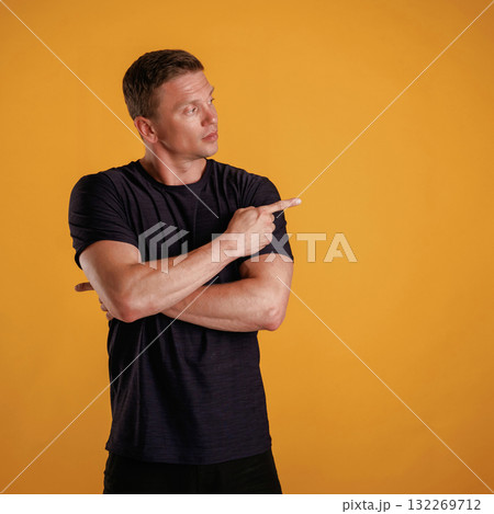 Invisible copy space, arms. Man is against background in the studio Invisible copy space, arms. Man is against background in the studio 132269712