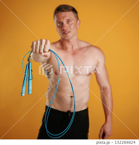 Blue jumping rope, fitness conception. Man is against background in the studio Blue jumping rope, fitness conception. Man is against background in the studio 132269824