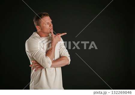 New product, showing at copy space. Man is against background in the studio 132269846