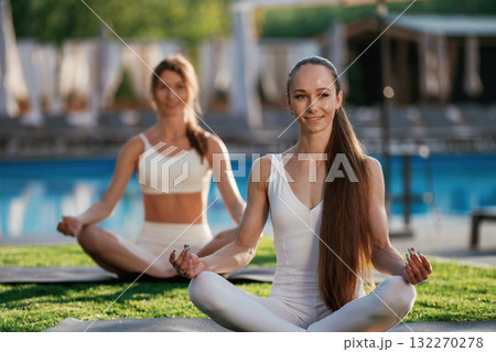 Lotus pose, meditation. Two fitness women are together outdoors, conception of sport 132270278