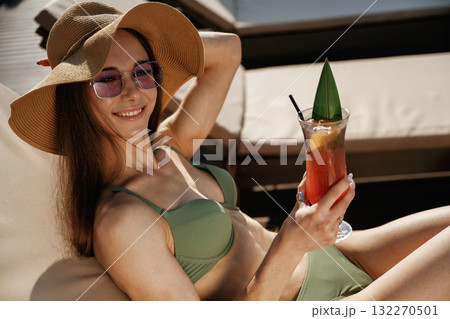 Relaxing, vacation time. Beautiful young woman is at resort Relaxing, vacation time. Beautiful young woman is at resort 132270501