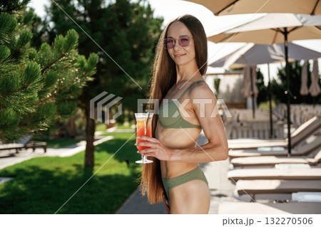 Front view, standing. Beautiful young woman is at resort, vacation Front view, standing. Beautiful young woman is at resort, vacation 132270506