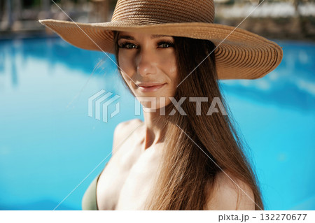 Portrait, in the straw hat. Beautiful young woman is at resort, vacation 132270677