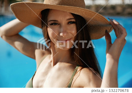 Portrait, in the straw hat. Beautiful young woman is at resort, vacation 132270678