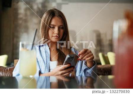 Young beautiful woman is in the restaurant 132270830