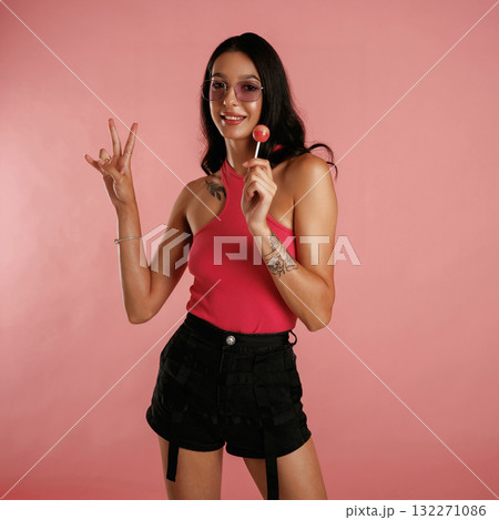 Sweet lollipop. Beautiful young woman is against background 132271086