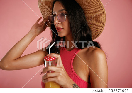 Fresh drink. Beautiful young woman is against background Fresh drink. Beautiful young woman is against background 132271095