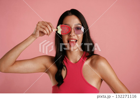 Summer fresh ice cream. Beautiful young woman is against background 132271116