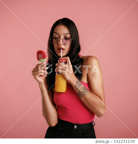 Summer fresh ice cream and orange juice. Beautiful young woman is against background Summer fresh ice cream and orange juice. Beautiful young woman is against background 132271119