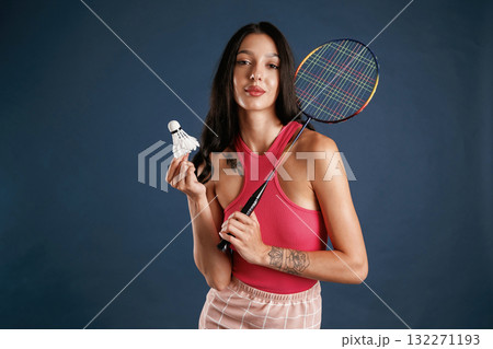 With racket for badminton sports. Beautiful young woman is against background With racket for badminton sports. Beautiful young woman is against background 132271193