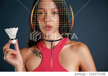 Hobby conception, badminton player. Beautiful young woman is against background Hobby conception, badminton player. Beautiful young woman is against background 132271198