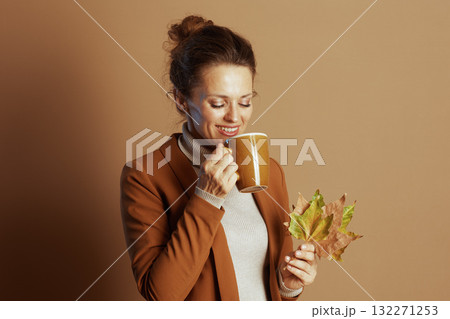 Content Businesswoman Enjoys a Cozy Autumn Moment 132271253