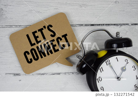 Let's connect text with alarm clock on wooden background 132271542