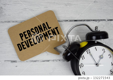 Personal development text with alarm clock on wooden background 132271543