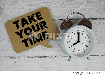 Take Your Time text with alarm clock on wooden background 132271548