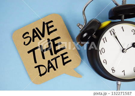 Save The Date text with alarm clock on blue background Save The Date text with alarm clock on blue background 132271587