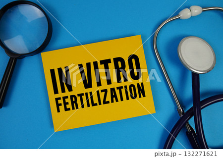 IVF In Vitro Fertilization text with Stethoscope and magnifying glass on blue background 132271621